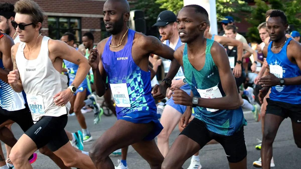 The Boulderthon lead pack racing down a downtown Boulder street.